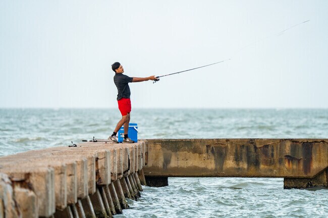 In the City of Corpus Christi local fisherman enjoys one of the Bay Area public accessible piers found throughout.
