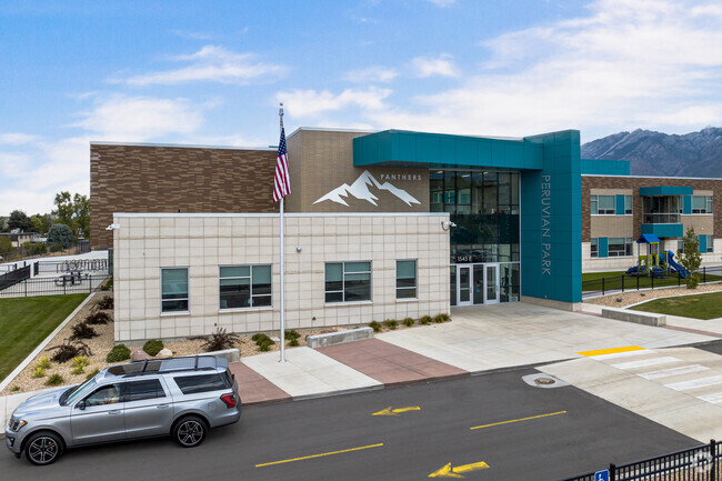 A glass entrance framed by blue details at Peruvian Park Elementary.
