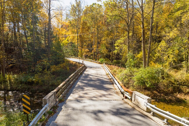 Bridges connect winding trails across scenic streams in Susquehanna Trails’ hilly terrain.