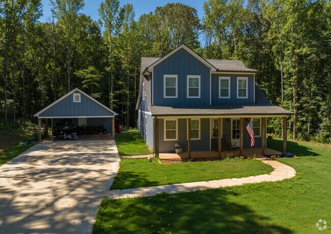 Modern farm houses are tucked away under green landscapes in Whitesburg.