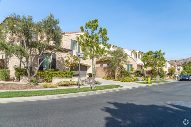 Row of beautiful homes with lush lawns, showcasing the serene charm of Orchard Hills.