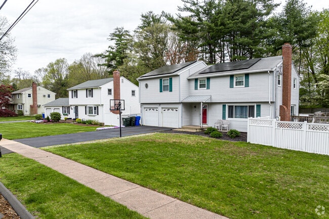 Quiet streets in East Hartford often include driveways with basketball hoops for neighborhood play.