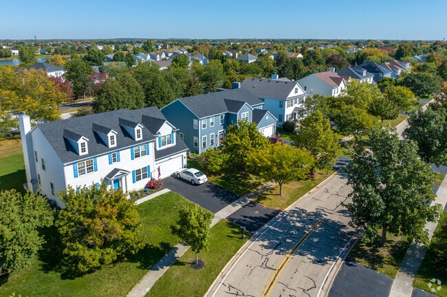 A tree lined residential street displays popular home styles in Freedom Park.