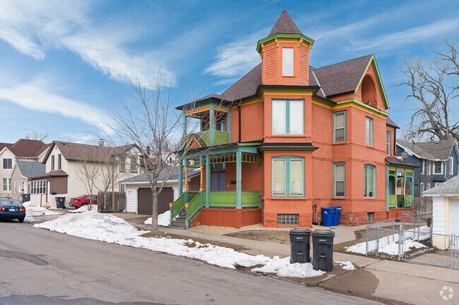 An orange-colored Victorian house with a turret in the Payne-Phalen neighborhood.