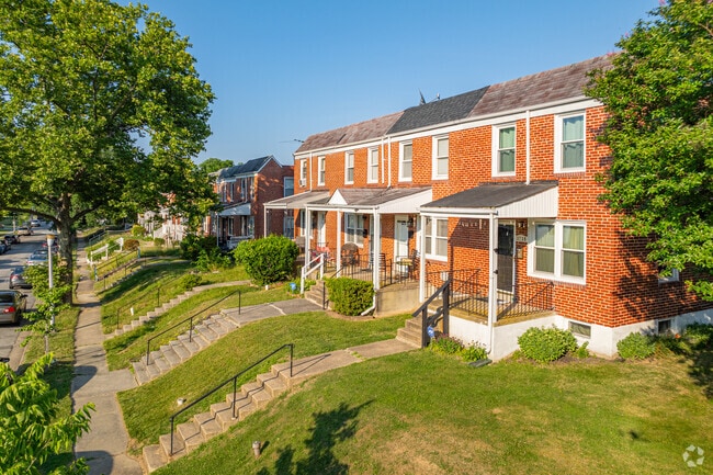 Red brick rowhomes featuring flat facades offer an affordable option for living in Rosemont.