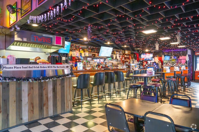 Inside Knuckleheads Bar & Grill, checkered floors and festive decor create a lively atmosphere.