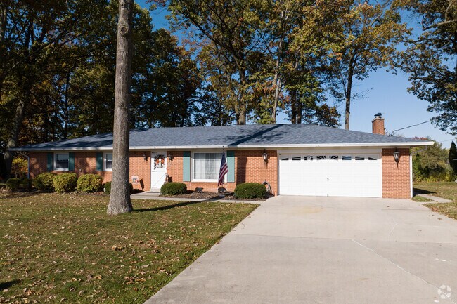 Brick ranch-style homes are shaded by mature trees in Parkville.