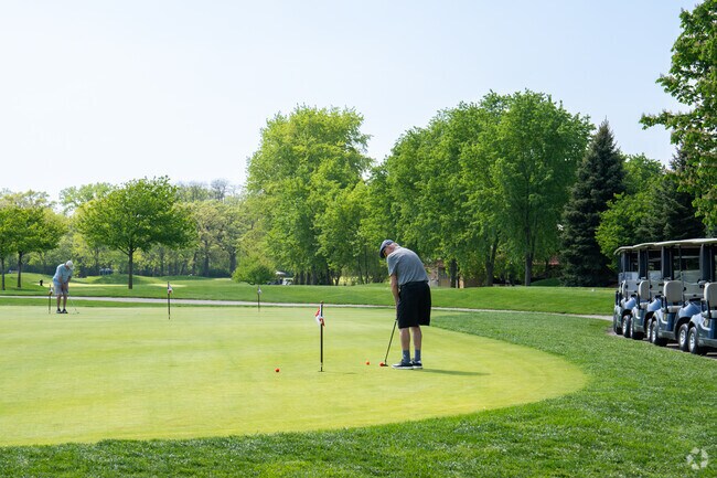 A golfer practices at Arrowhead Golf Club.