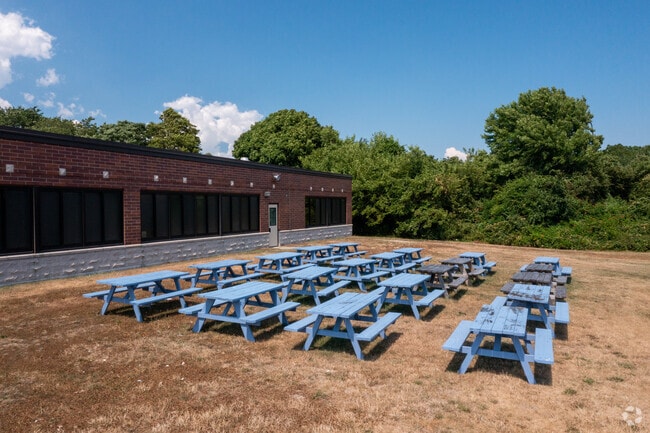 There are outdoor lunch tables for students at The Bridges Academy.