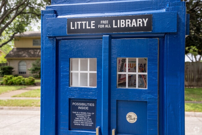 Duck Creek locals stop by their Little Free Library to find books.