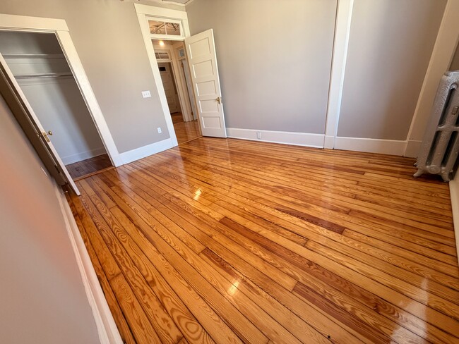 large bedroom with hardwood floors