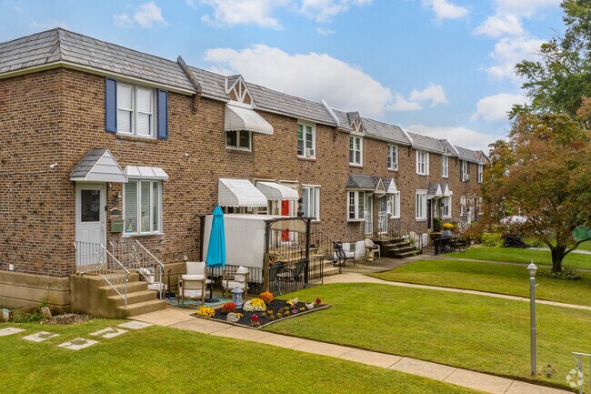 Find attached row homes in Collingdale with front yard gardens and paved walkways.