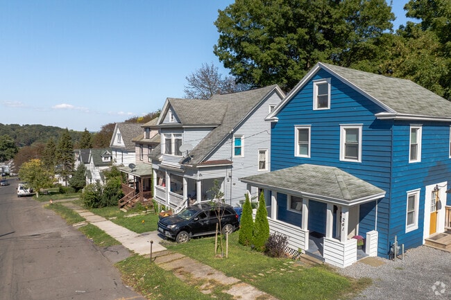 A row of Colonial Revival homes lines a curved Strathmore boulevard.