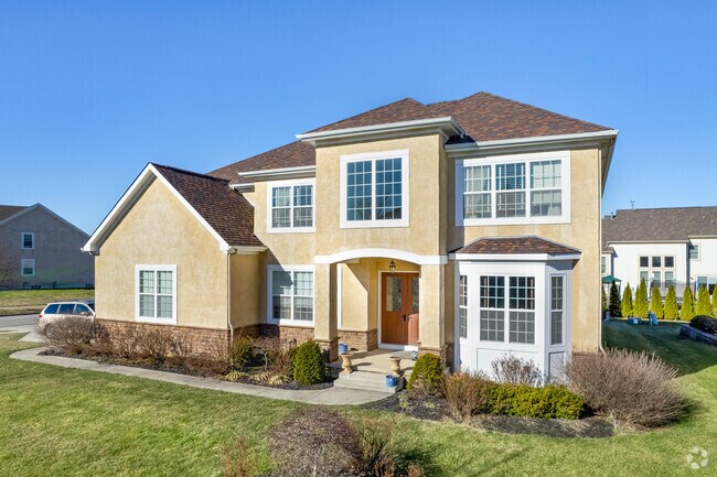 A contemporary two-story home in Tuttle West features a well-maintained lawn.