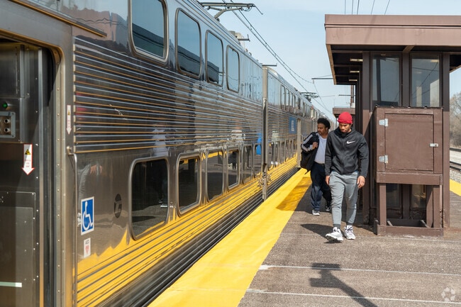 Commuters board a Chicago-bound train at the Olympia Fields METRA station near Chicago Hts.