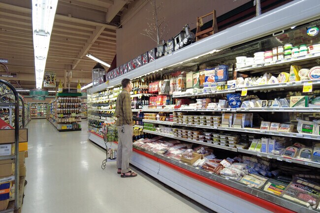 Shoppers at Ben Lomond Market browse a well-stocked deli and cheese case, a favorite local stop for fresh ingredients, specialty items, and everyday essentials.