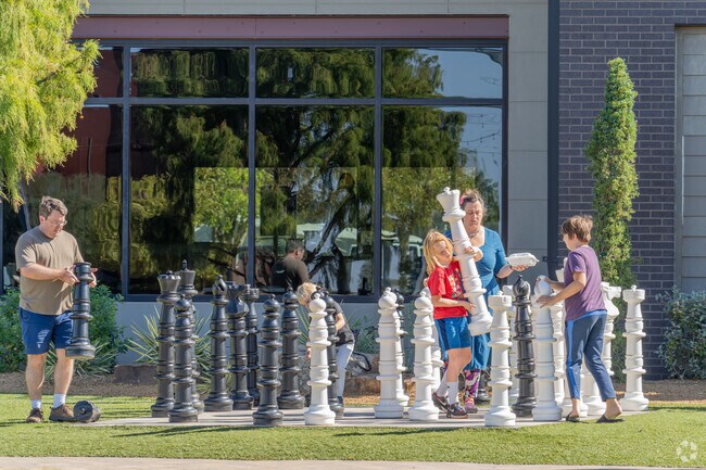 Kids enjoy playing giant chess at Chisholm Creek, just a short drive from Macklanburg Park.