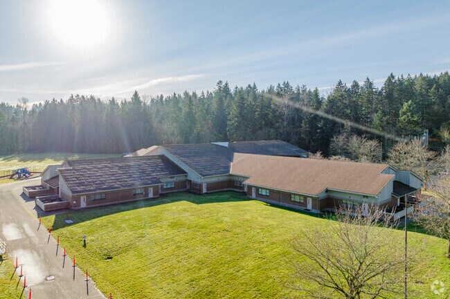Aerial views of the school and surrounding trees.