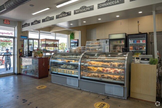 The front counter at Pinolandia in Welwyn Park displays fresh baked treats, meats, and cheeses.