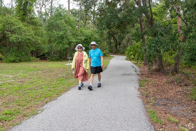 People enjoy walking the quiet paths at Conservatory Park near Desoto Acres.
