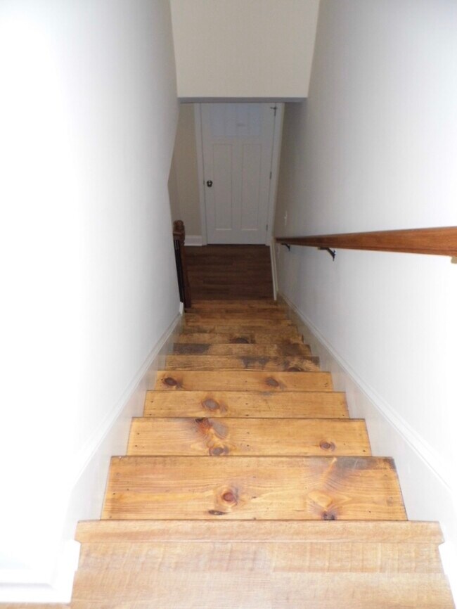 Beautiful hardwood stairs lead to the temperate sleeping and bathing area