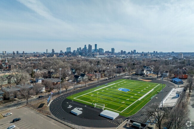 An aerial view of the North High School football field with downtown in the background.
