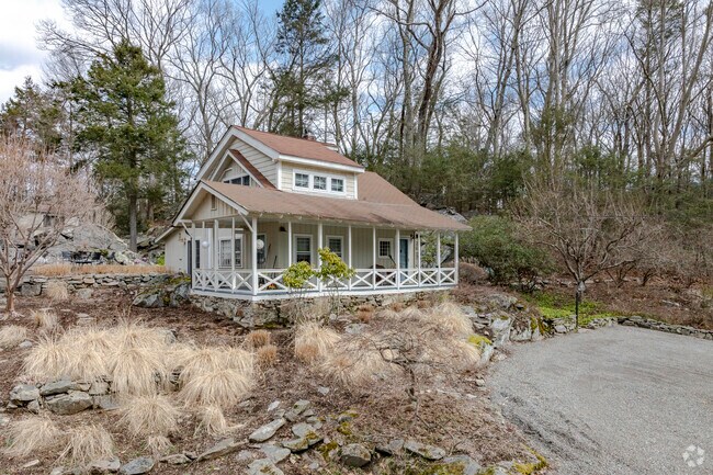 This homes porch on Bishop Park Road in Pound Ridge offers views of a nearby pond.