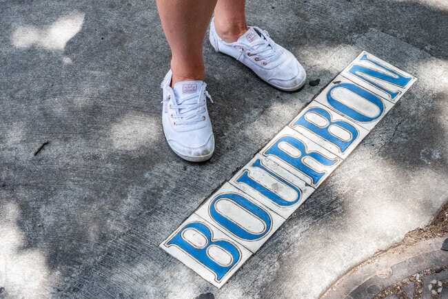 The Bourbon street sign on the sidewalk in the French Quarter neighborhood.