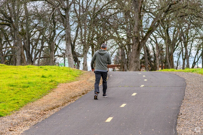 Man enjoys walk through peaceful bike trails of the Blue Oaks Park trails in Quail Glen.