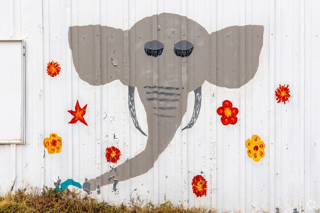 A small elephant mural adorns a building beside the Dibble Community Center.