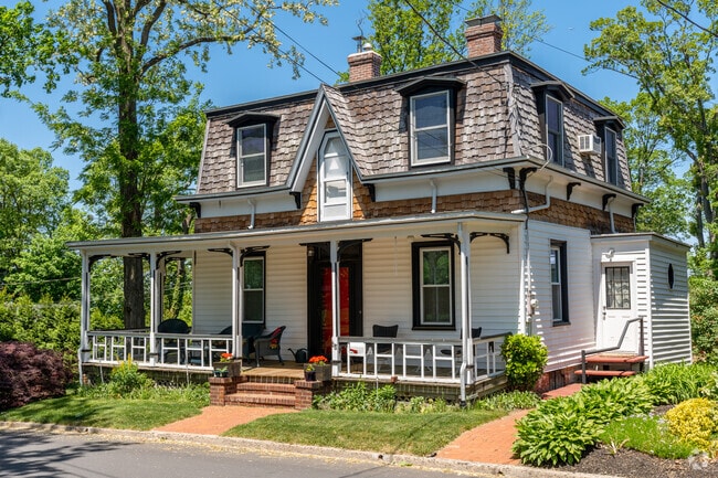 Sea Cliff home with mixed siding and wood shingles shows creative design.