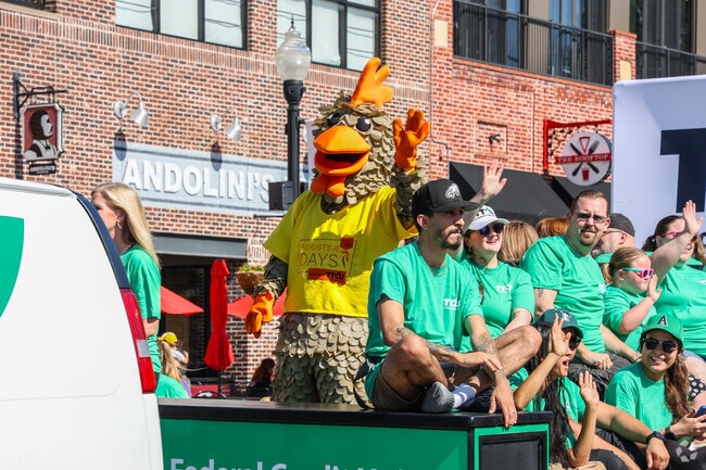 The rooster joins the TTCU float in the Rooster Days Parade.