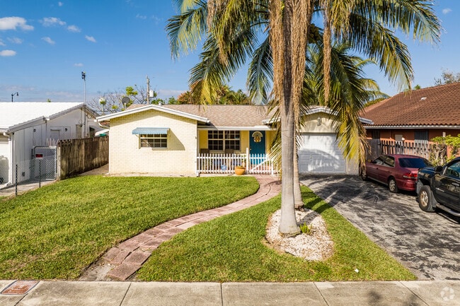 A colorful ranch style home with lush greenery in the Highlands neighborhood.