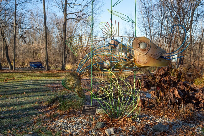'The River (Runs Through Us)' sculpture stands by the river in the Dimondale neighborhood.