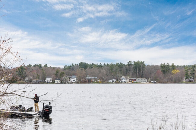 A fisherman enjoys a quiet afternoon on Lake Mascuppic in Dracut.