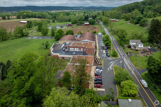 The American flag waves proudly in front of Ethel Hoppock Middle School in Bethlehem, NJ, symbolizing unity and community spirit.