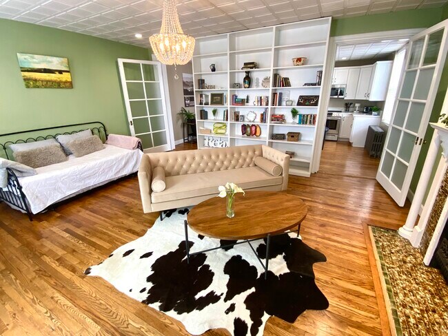 Living Room Can Also Function as Second Bedroom with Frosted Doors for Privacy