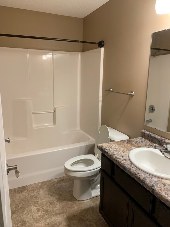 One of two similar full bathrooms