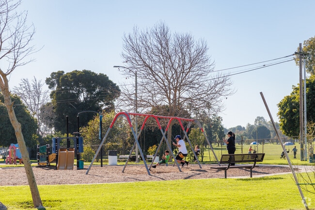 Enjoy the swing set and playground with your kids on a sunny day at Alondra Park.