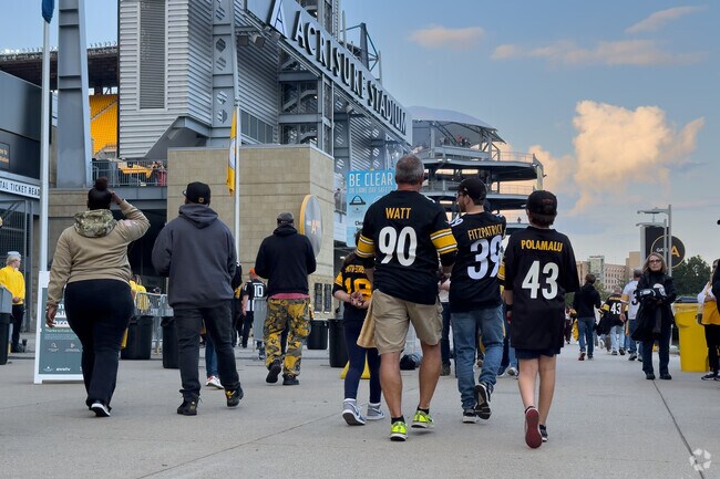 Pittsburgh Steelers fans see a game at Acrisure Stadium across the river from The Point.
