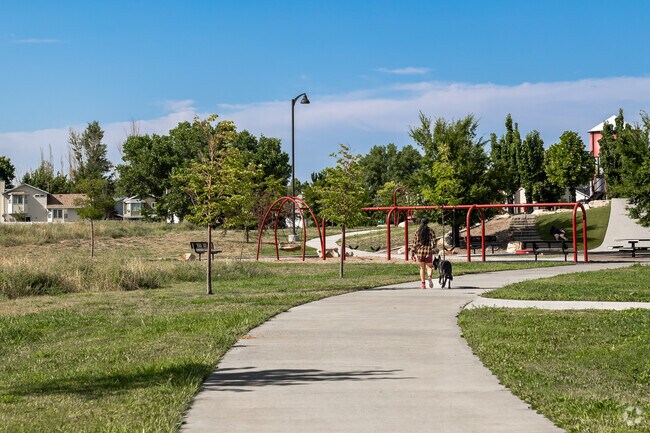 A resident walks her dog on one of the many paths at Lodestone Regional Park.
