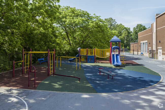 The playground at Evanston Academy Elementary School is vibrant and shaded.