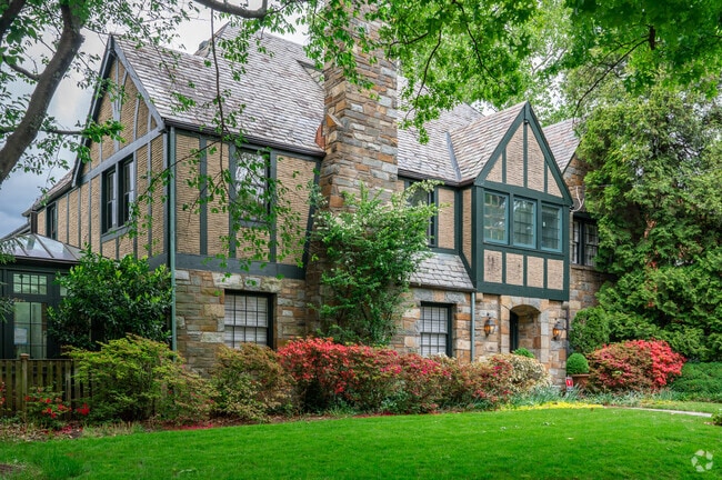 A green-accented Tudor-style home in the Forest Hills neighborhood.