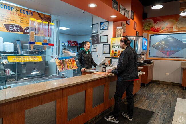 A Steger resident orders a treat at Scoop Cones Ice Cream Shop, located inside Brick Oven Pizza.