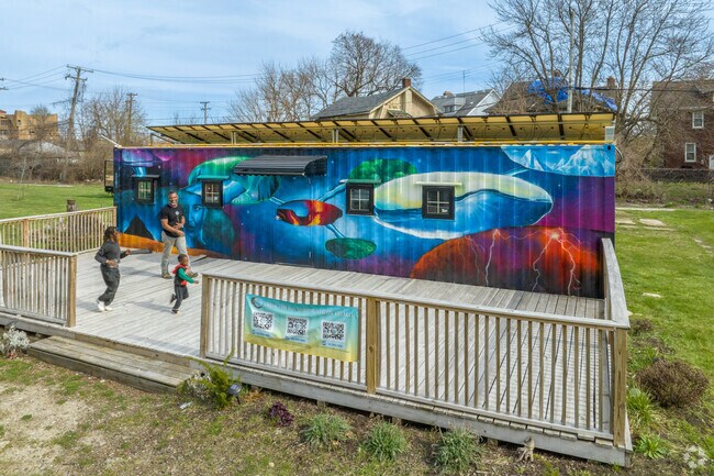 A family plays in front of the Imhotep STEAM Lab in Highland Park.