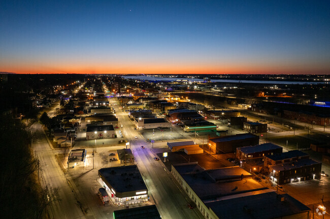 Downtown East Moline sparkles against the backdrop of the Mississippi River at sunset.