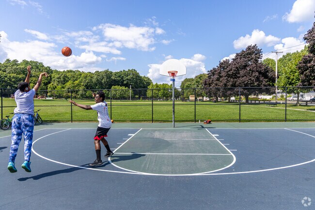A group of locals play basketball at the Swasey Field Park in Haverhill, MA.