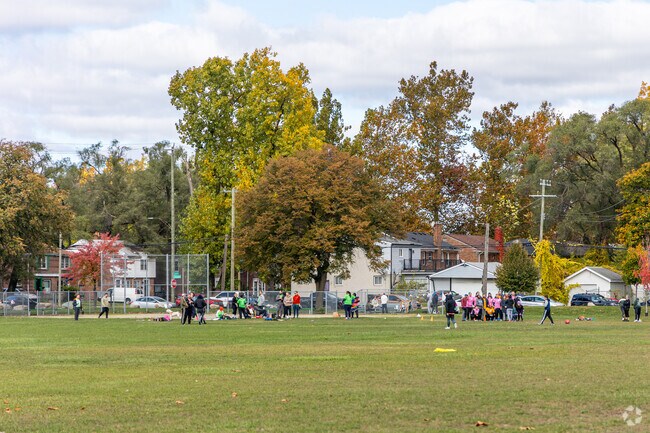 A large group of people get together to play kickball at Peterson Playfield.