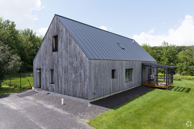 A modern styled new home with a lovely metal roof in Guilderland.