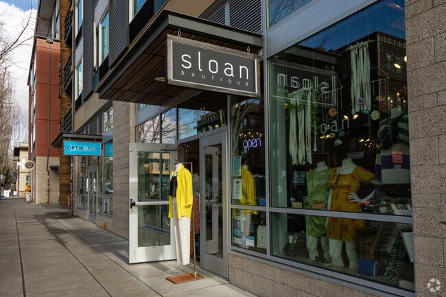 A row of small walk-in retail shops lines a street in Boise, Portland.